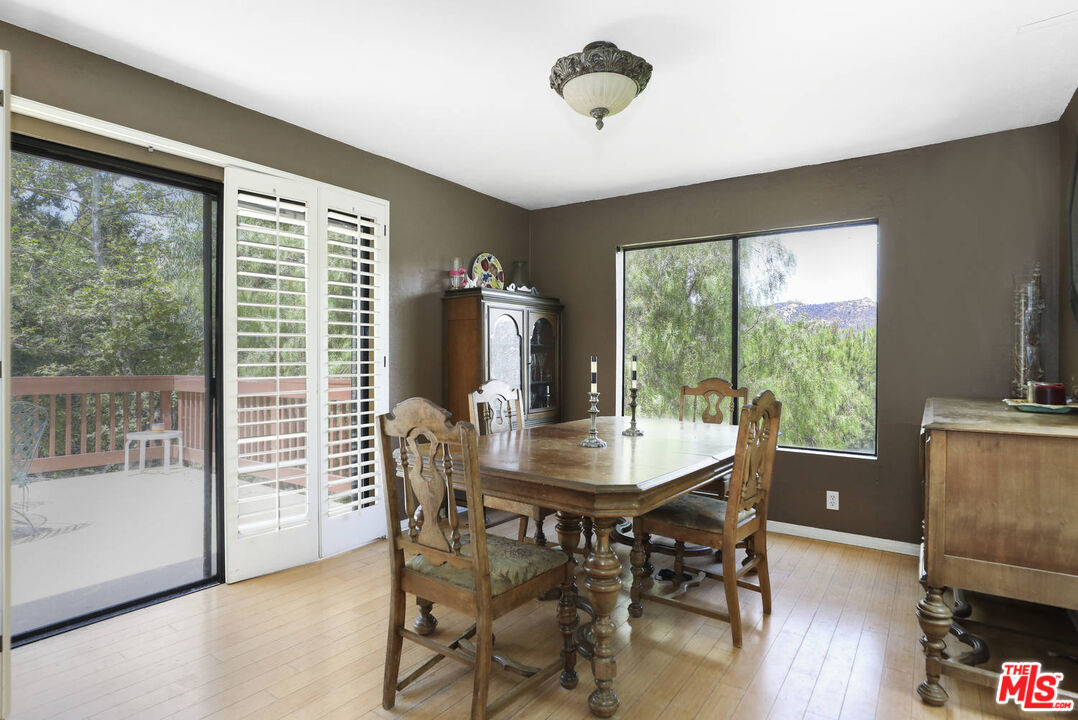 1926 Corral Canyon Road Malibu, CA 90265 - Photo 9 of 29 a view of a dining room with furniture window and wooden floor