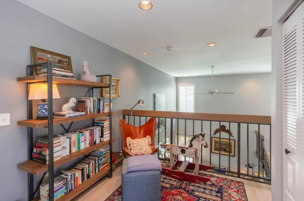 a living room with lots of furniture and a book shelf