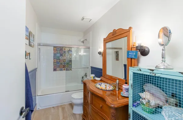 a bathroom with a toilet sink and mirror