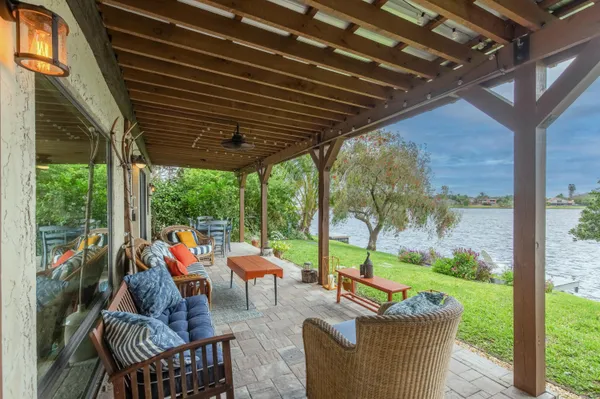 a view of a patio with table and chairs and potted plants