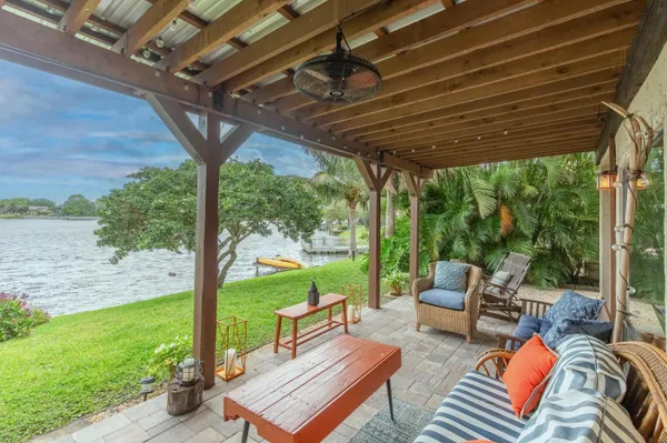 a view of a chair and table in backyard of the house