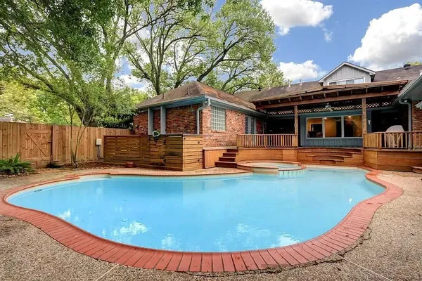 a view of a house with swimming pool and porch