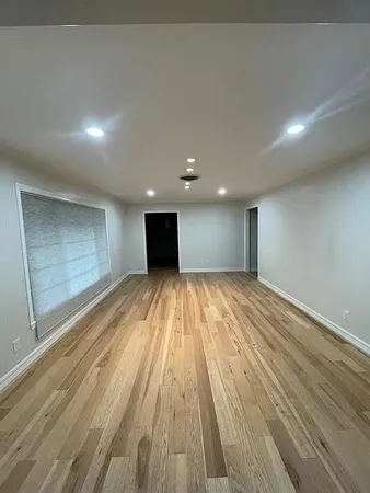 a view of room with wooden floor and staircase