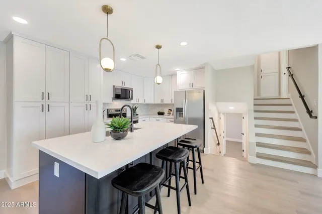 a kitchen with a table and chairs in it