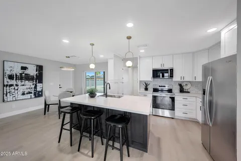 a large kitchen with a table and chairs