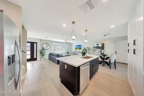 a large kitchen with a table and chairs