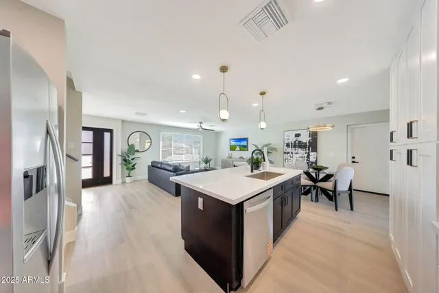 a large kitchen with a table and chairs