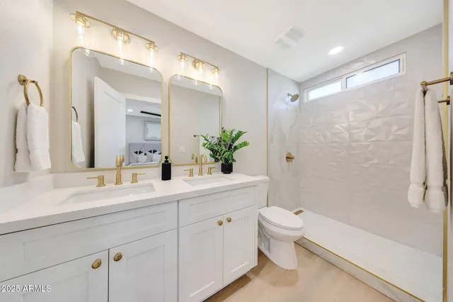 a bedroom with a bed dresser flowerpot and window