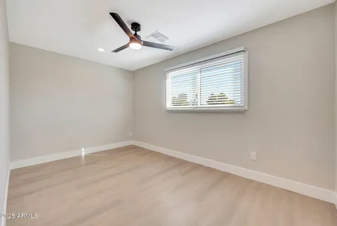 a view of a hallway with wooden floor and closet