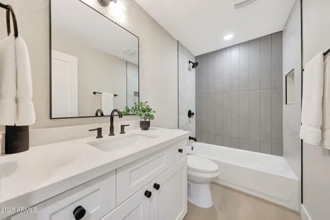 a view of a hallway with wooden floor and windows