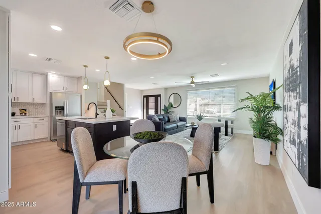 a view of a dining room with furniture and a floor to ceiling window