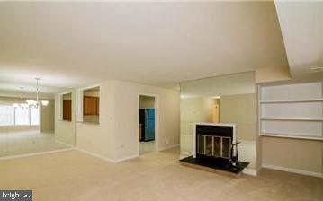 a view of an empty room with a fireplace