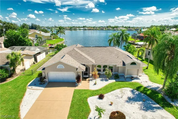 a aerial view of a house with swimming pool garden and patio