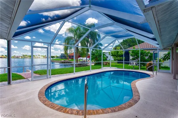 a view of a backyard with swimming pool
