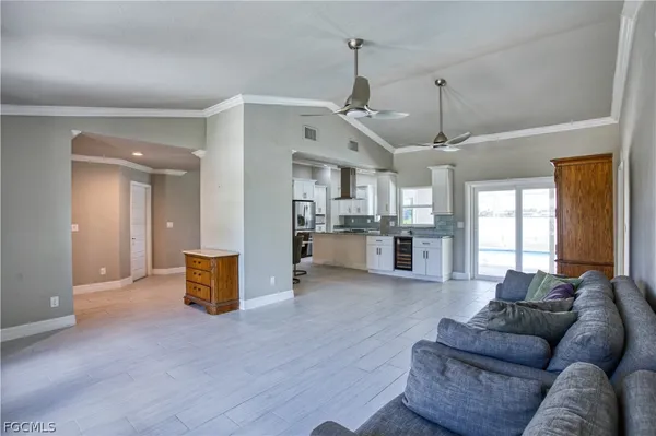 a living room with furniture and kitchen view