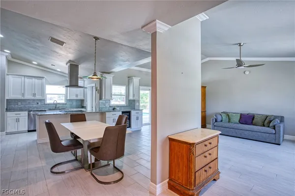 a living room with furniture and kitchen view