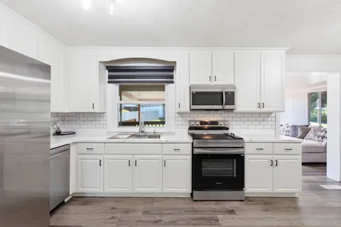 a kitchen with a stove oven and sink