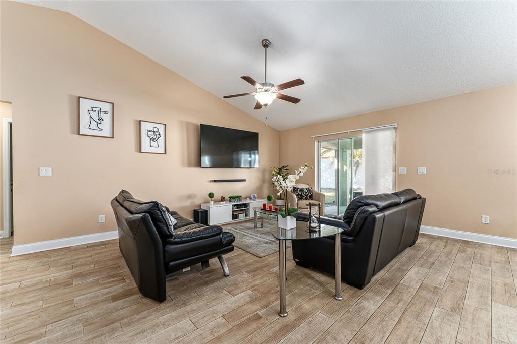 9961 Southwest 55th Ave Road Ocala, FL 34476 - Photo 14 of 89 a living room with furniture and a flat screen tv