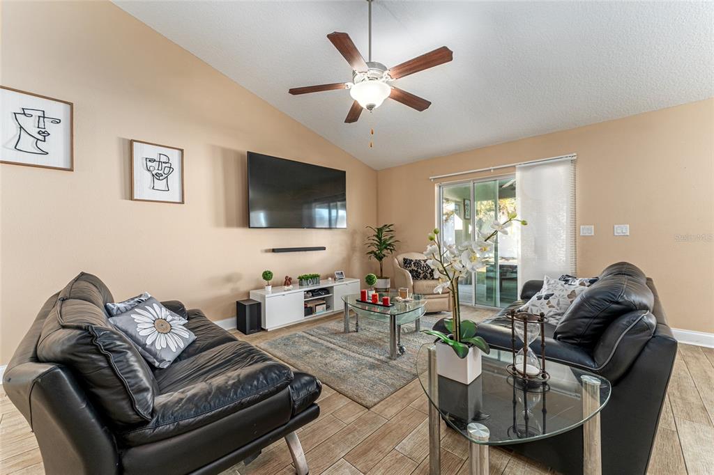 9961 Southwest 55th Ave Road Ocala, FL 34476 - Photo 15 of 89 a living room with furniture and a flat screen tv