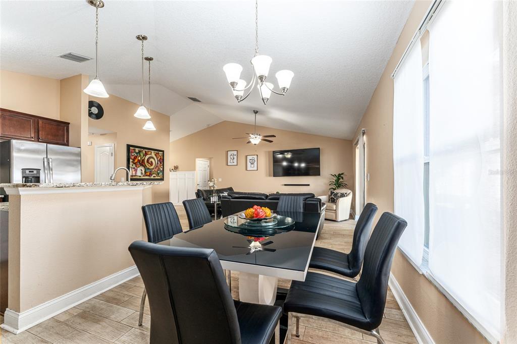 9961 Southwest 55th Ave Road Ocala, FL 34476 - Photo 24 of 89 a view of a dining room with furniture and a chandelier