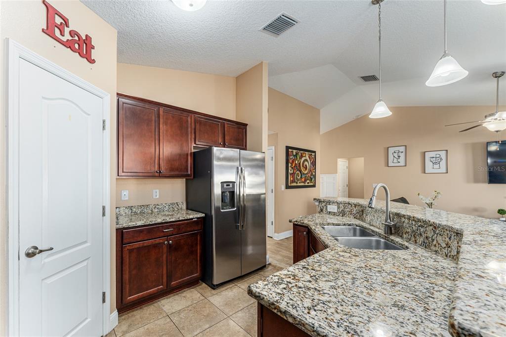 9961 Southwest 55th Ave Road Ocala, FL 34476 - Photo 30 of 89 a kitchen with stainless steel appliances granite countertop a sink refrigerator and cabinets