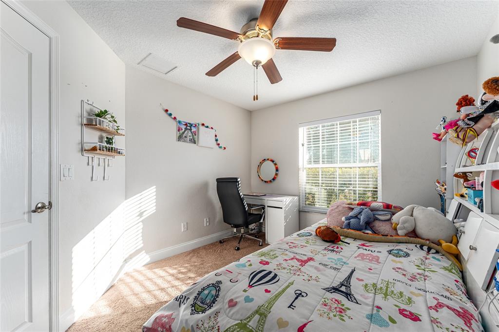 9961 Southwest 55th Ave Road Ocala, FL 34476 - Photo 34 of 89 a bedroom that has a bed and a table in it