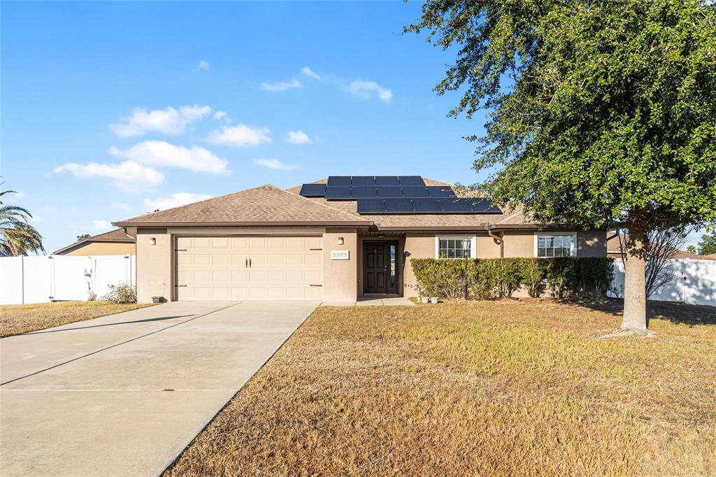 9961 Southwest 55th Ave Road Ocala, FL 34476 - Photo 4 of 89 a front view of a house with a yard and garage