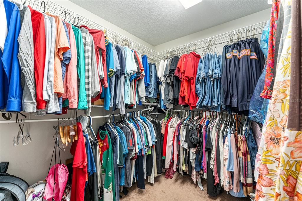 9961 Southwest 55th Ave Road Ocala, FL 34476 - Photo 49 of 89 a view of walk in closet with clothes