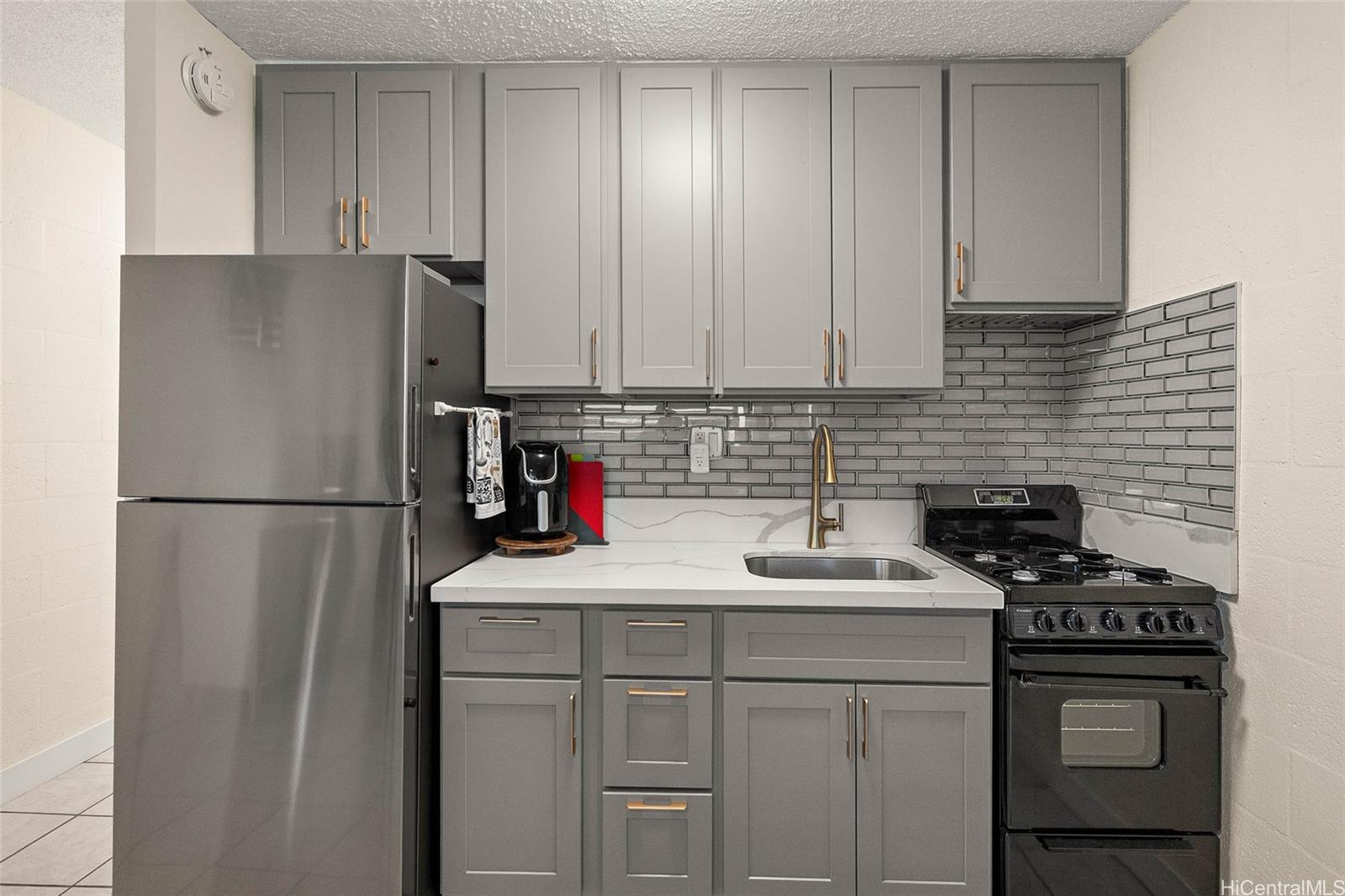 1863 Kaioʻo Drive, Unit 302 Honolulu, HI 96815 - Photo 3 of 10 Newly designed kitchen offers lots of cabinet space and a new range/oven, and refrigerator.