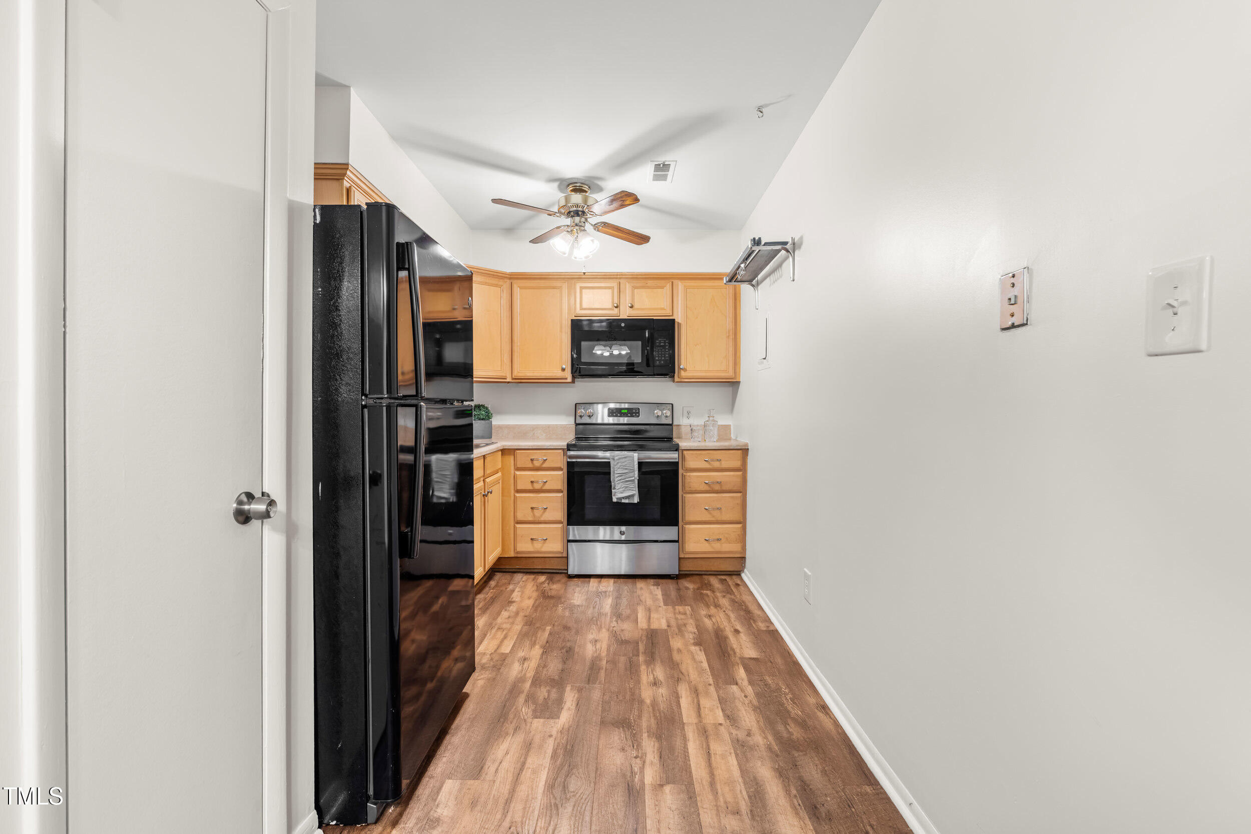 1212 Schaub Drive, Unit C Raleigh, NC 27606 - Photo 15 of 23 a large kitchen with stainless steel appliances granite countertop a stove and a refrigerator