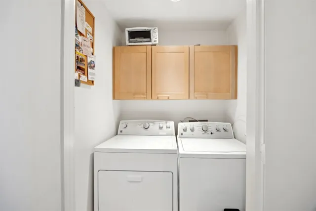 a bedroom with furniture and a large window