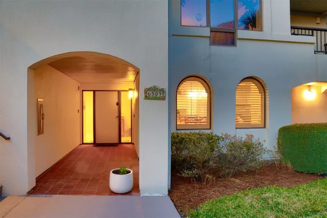 a kitchen with a sink dishwasher stove and white cabinets with wooden floor