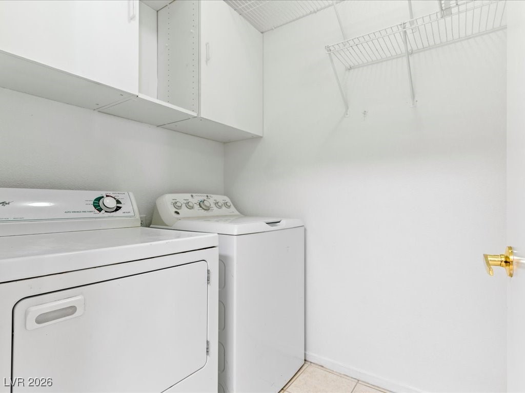 8725 West Flamingo Road, Unit 235 Las Vegas, NV 89147 - Photo 18 of 22 Laundry area with separate washer and dryer and light tile patterned floors