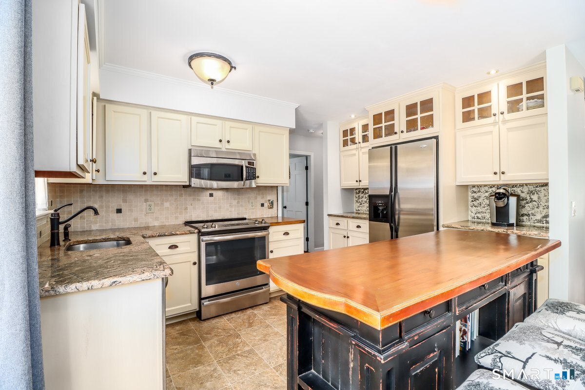 16 A Pole Bridge Road Newtown, CT 06482 - Photo 3 of 27 a kitchen with stainless steel appliances granite countertop a stove top oven a sink and a refrigerator