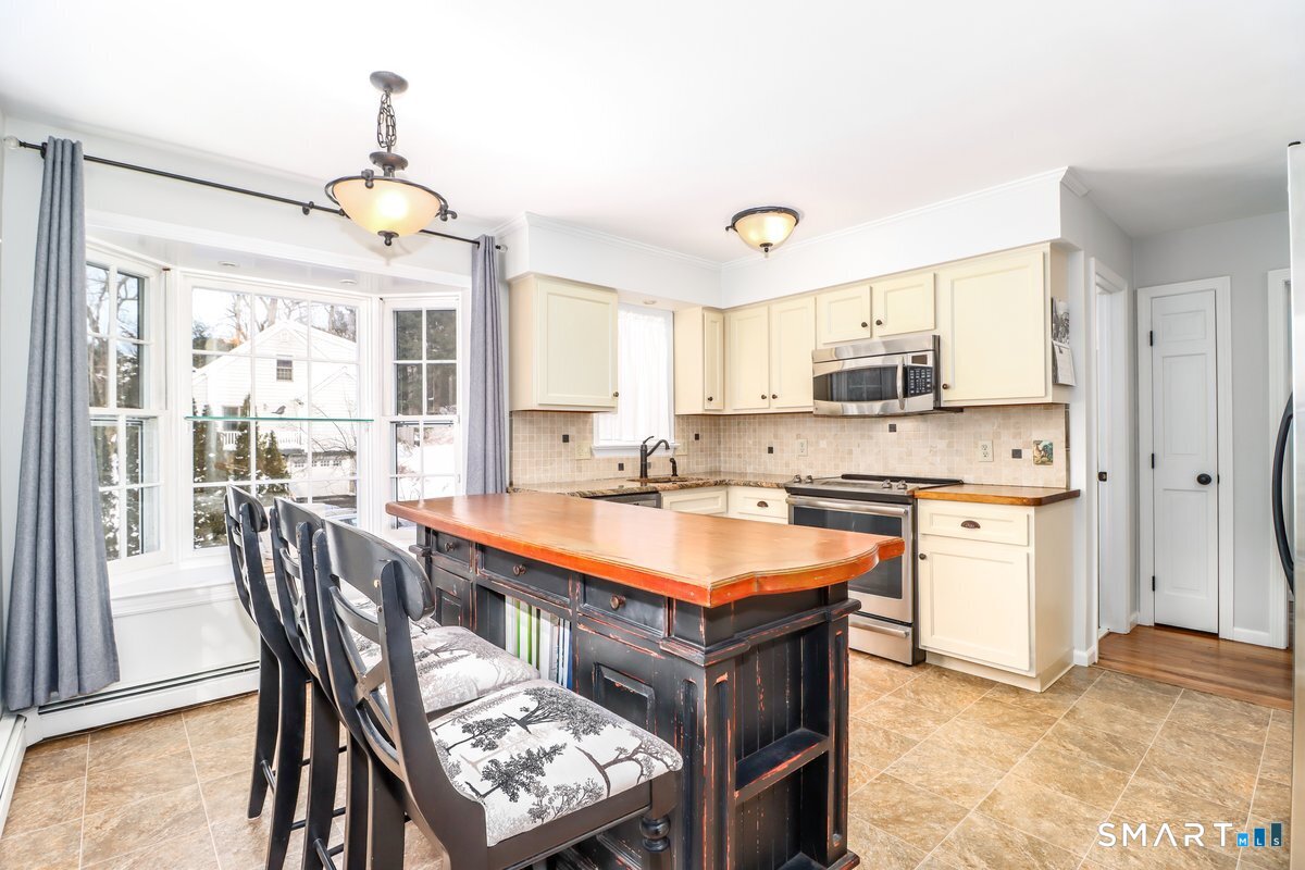 16 A Pole Bridge Road Newtown, CT 06482 - Photo 5 of 27 a large kitchen with a table chairs sink and cabinets