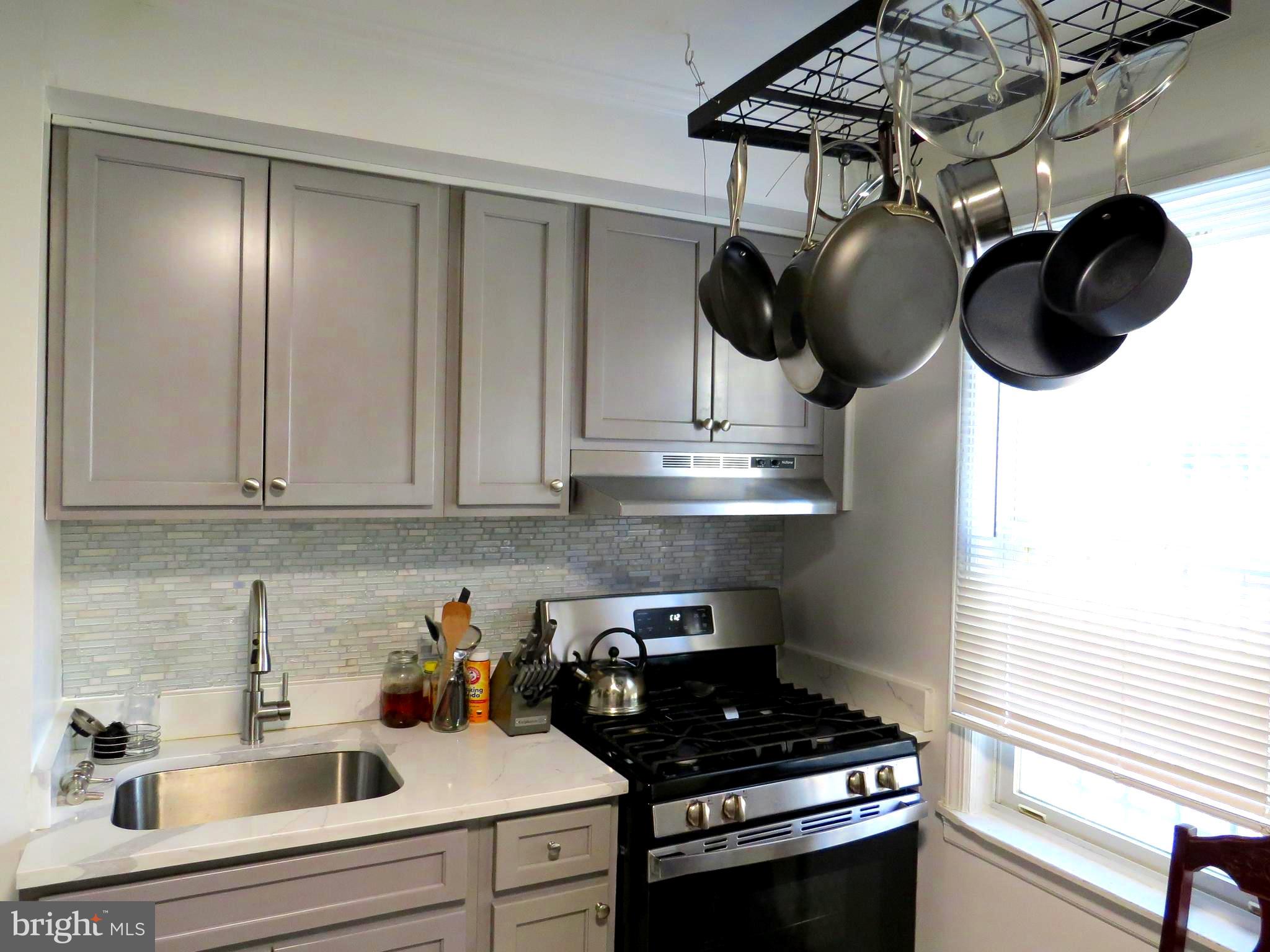 a kitchen with stainless steel appliances a sink a stove and cabinets
