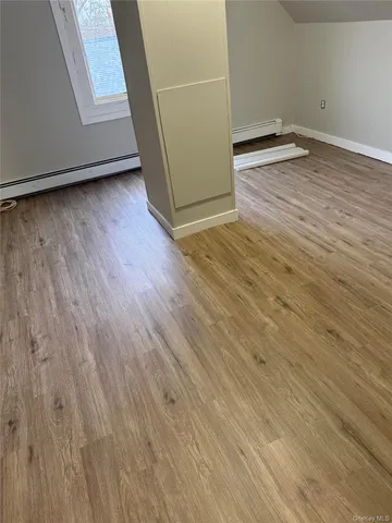 a view of a room with wooden floor