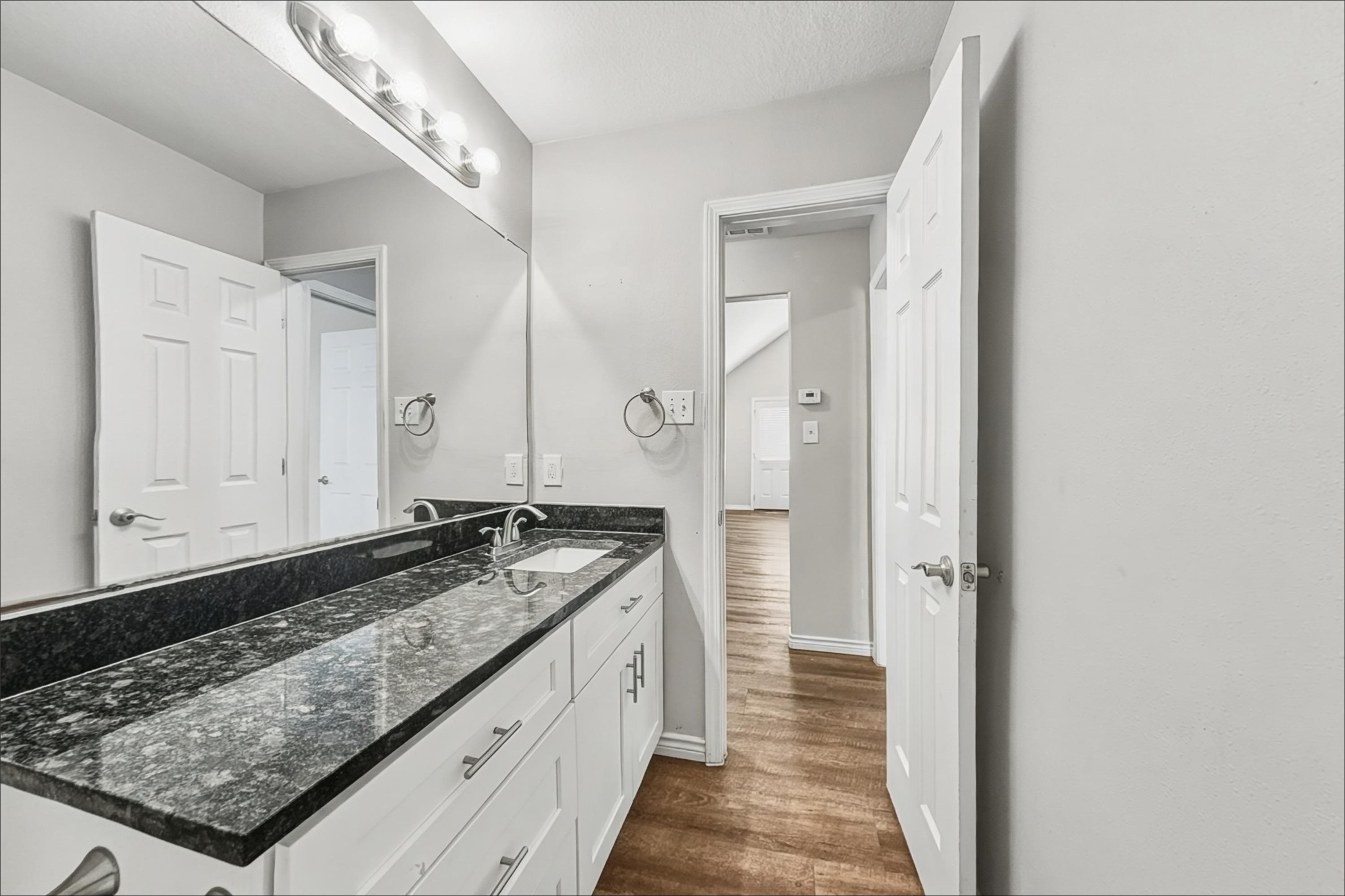 2423 Lofty Falls Court Spring, TX 77386 - Photo 13 of 15 a bathroom with a granite countertop sink and a mirror