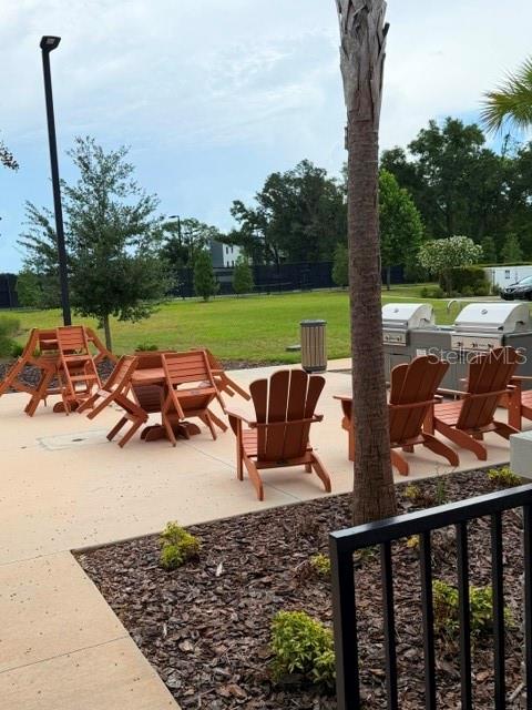 6259 Back Forty Loop Zephyrhills, FL 33541 - Photo 21 of 22 a view of a patio with lawn chairs floor to ceiling window and yard
