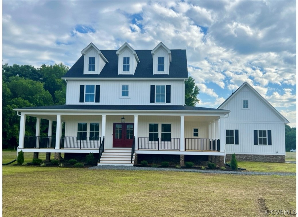 a view of a house with a big yard and large trees