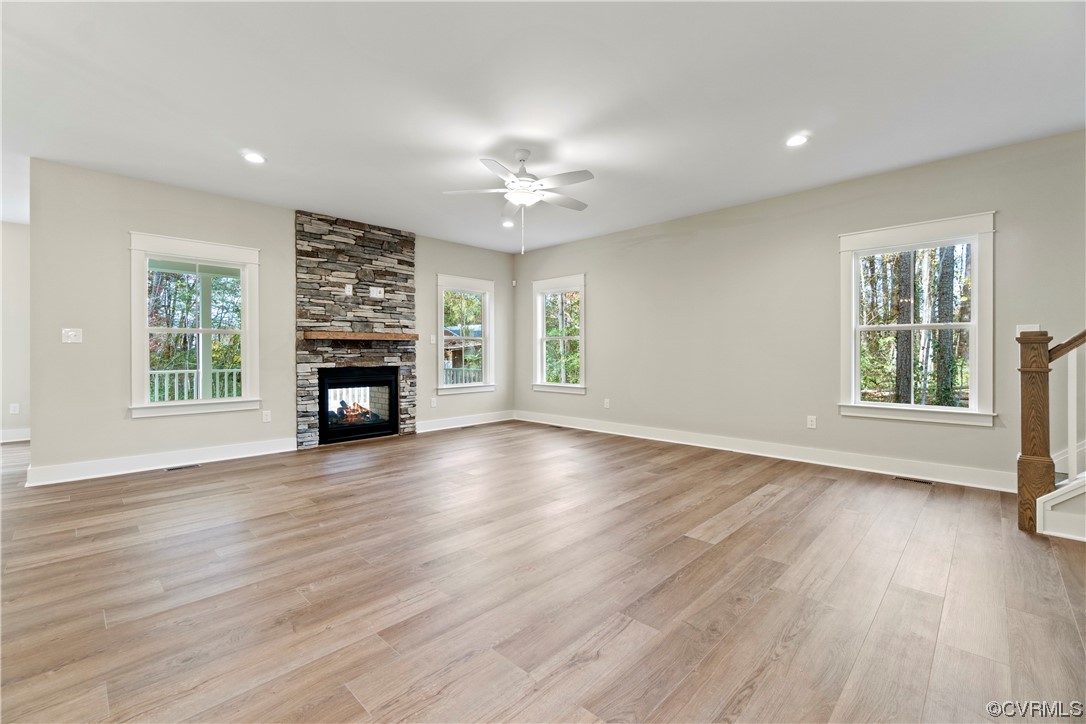 10010 Bo Trail Mechanicsville, VA 23116 - Photo 7 of 16 an empty room with windows fireplace and wooden floor