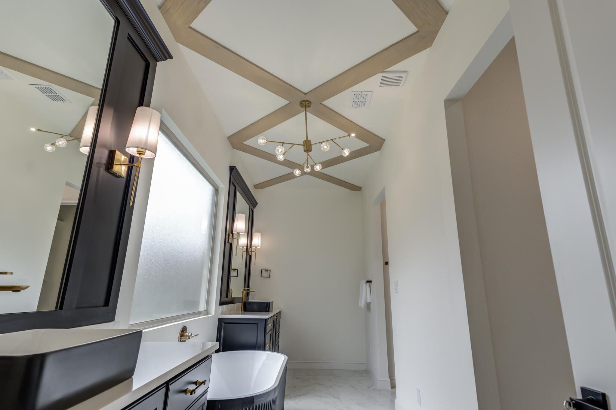 3612 143rd Street Lubbock, TX 79423 - Photo 74 of 91 a bathroom with a light fixture a mirror and a toilet