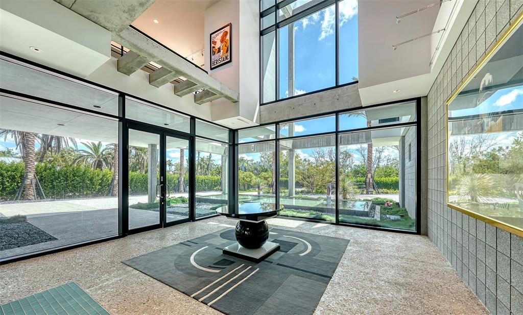 8250 Sanderling Road Sarasota, FL 34242 - Photo 13 of 61 a living room with hardwood floor and large windows