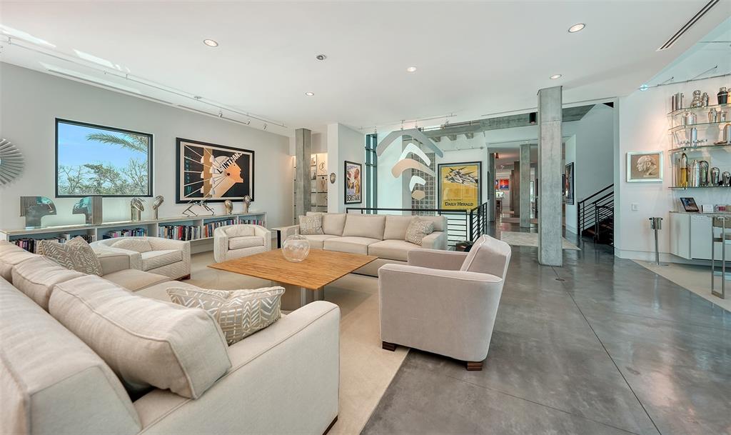 8250 Sanderling Road Sarasota, FL 34242 - Photo 14 of 61 a living room with furniture and a flat screen tv