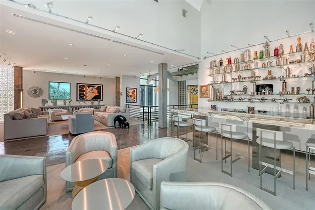 a dining room with furniture and a large window