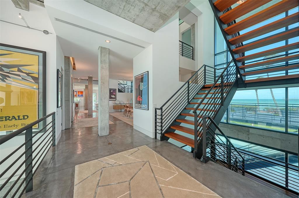 8250 Sanderling Road Sarasota, FL 34242 - Photo 19 of 61 a view of entryway and hall with wooden floor
