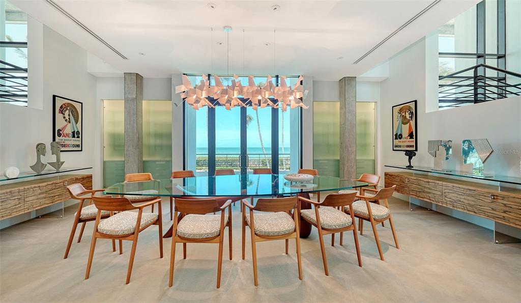 8250 Sanderling Road Sarasota, FL 34242 - Photo 20 of 61 a dining room with furniture and a large window