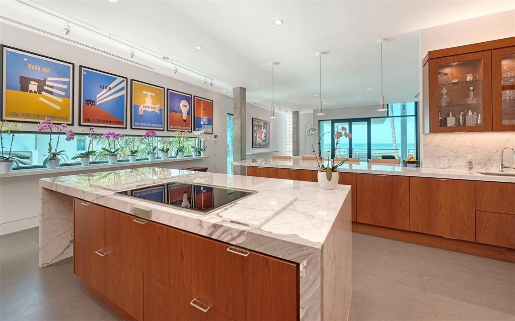 8250 Sanderling Road Sarasota, FL 34242 - Photo 25 of 61 a kitchen with granite countertop a sink and a refrigerator