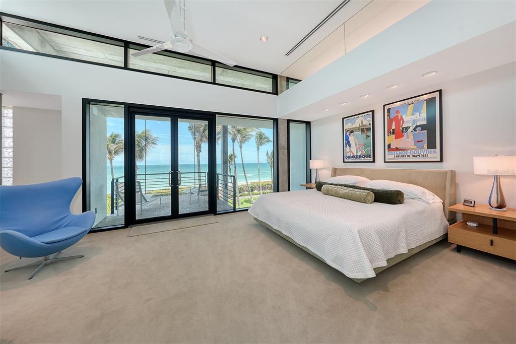 8250 Sanderling Road Sarasota, FL 34242 - Photo 28 of 61 a spacious bedroom with a large bed and a large window