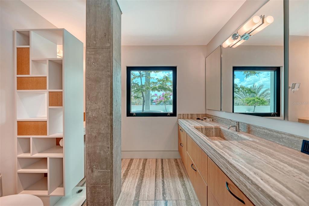 8250 Sanderling Road Sarasota, FL 34242 - Photo 32 of 61 a bathroom with a granite countertop sink and a large mirror
